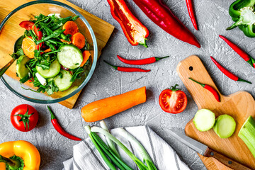 cooking vegetables on the stone background top view