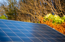 Solar Panel Generating Electricity And Fall Colours On A Sunny Day In Autumn