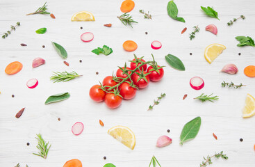  top view of various types of aromatic herb leaves and cut vegetables on wooden background