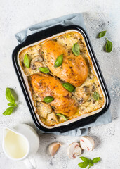 Canvas Print - Baked chicken fillet with mushrooms in cream sauce. Top view on white kitchen table.