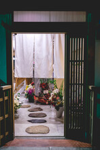 Traditional Entrance At Japanese Tea House With Stones And Flowers, Kyoto, Japan