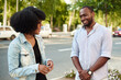 © etonastenka - An African American woman and a black man talk about the news of the day while standing on a city street