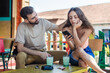 © guruXOX - Alienation addiction. Young couple sitting in cafe and typing on their own phones