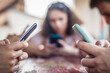 © guruXOX - Alienation addiction. Group of friend sitting in cafe and typing on their own phones