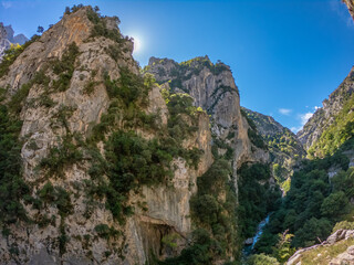 The Cares Route in the heart of Picos de Europa National Park, Cain-Poncebos, Asturias, Spain. Narrow and impressive canyon between cliffs, bridges, caves, footpaths and rocky mountains.