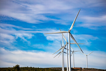 Wind turbines, renewable energy on a green hill. Wind farm