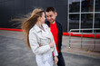 © DSMT - Stylish young girl with blond hair of European appearance and a guy in a black jacket. Urban walk of a couple in love, modern fashion in casual style. Happy relationship concept