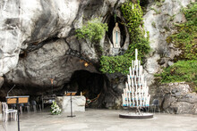 Statue Of Our Lady Of Immaculate Conception With A Rosary In The Grotto Of Massabielle In Lourdes