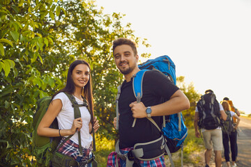 Wall Mural - young hikers with backpacks during vacation trip