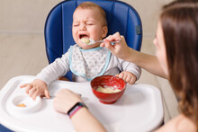 Mother Tries To Feed With Spoon Naughty Infant Kid Refusing Eating