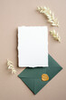 Wedding details card template. Blank paper card and green envelope with dried flowers. Flat lay, top view, copy space.