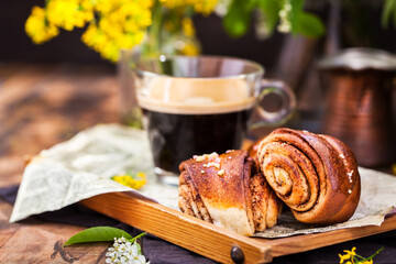 Wall Mural - Homemade cinnamon and cardamom rolls (buns) and cup of black coffee