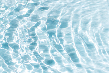 blue water surface with bright sun light reflections, water in swimming pool background.