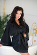 © Konstantin Koekin - Beautiful sexy brunette in black bathrobe takes a bath, spa treatments. Sensual woman in the bathroom