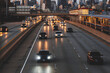© RooM The Agency - City skyline and cars driving along freeway at sunset, Chicago, Illinois, USA