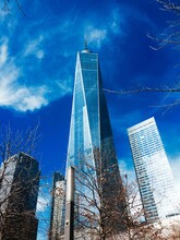 Low Angle View Of One World Trade Center In City Against Blue Sky