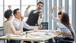 © Bangkok Click Studio - Group of five diversity businessmen, two men and three women sitting at meeting desk. They excited and greeting for good news and success result of their team.