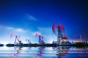 Wall Mural - Oil pumping machinery in operation, crude oil extraction scene in the night, North China