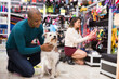 Portrait of happy man with beloved dog in pet shop