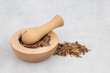 Cascara Herb Bark Used In Herbal Medicine To Treat Constipation In A Wooden Mortar With Pestle And Loose. Rhamnus Purshiana.