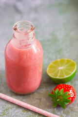 Wall Mural - Strawberry smoothie in bottle on metal background