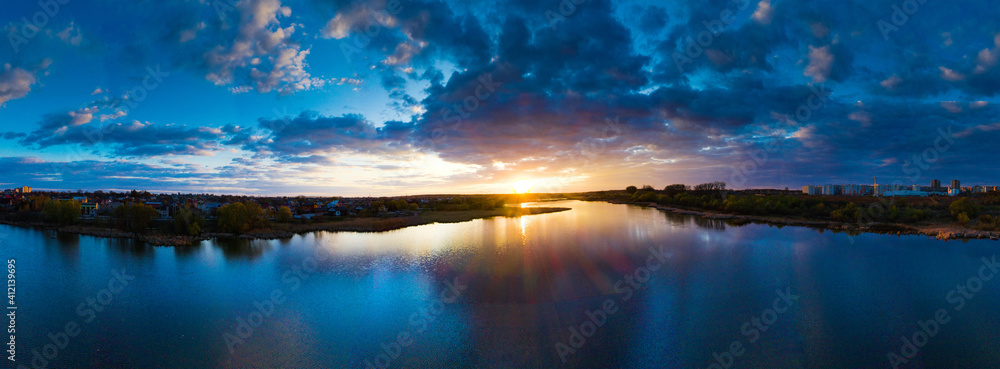 Beautiful sunrise and dramatic clouds on the sky. Flood waters of river. Panorama landscape - obrazy, fototapety, plakaty 