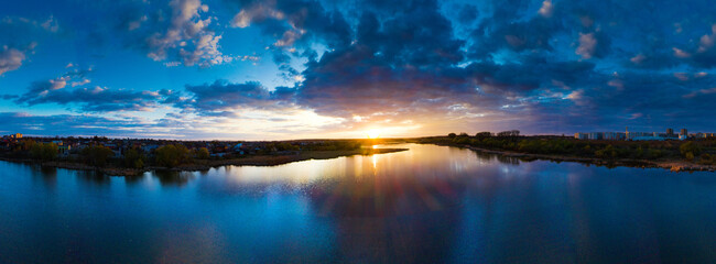 Wall Mural - beautiful sunrise and dramatic clouds on the sky. flood waters of river. panorama landscape