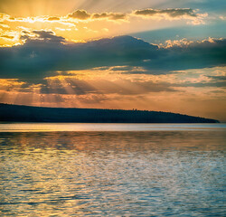Wall Mural - rays of sun shining through the clouds.