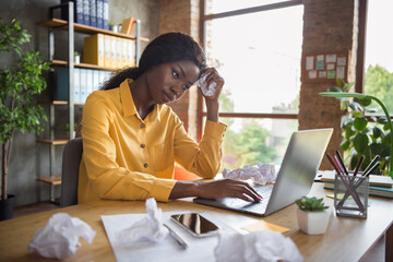 Sticker - Photo of tired afro american young business woman use laptop exhausted office job sit table indoors in workplace