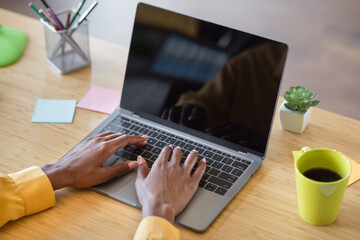 Poster - Photo of girl hands typing on laptop table wear yellow shirt at home