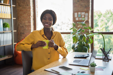 Poster - Photo of afro american happy business woman hold cup sit office desk take break work indoors in workplace