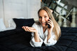 © F8  \ Suport Ukraine - Beautiful young woman with towel on head talking on phone in bedroom at home