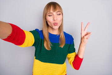 Sticker - Photo portrait of cute girl taking selfie sending air kiss pouted lips with camera isolated on pastel grey color background