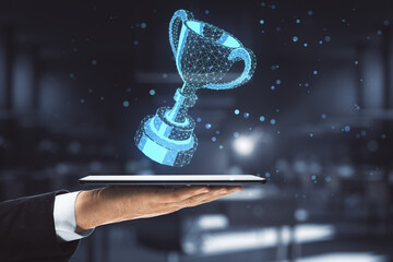 Businessman hand holding digital tablet with digital polygonal winner cup