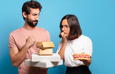 Wall Mural - young couple having take away fast food to home.