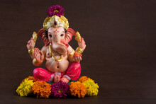 Close-up Of Ganesha Statue Against Colored Background