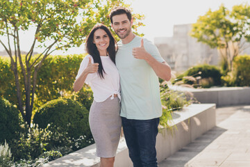 Sticker - Photo of cheerful couple posing together raise two thumbs up wear casual clothes in garden park outside