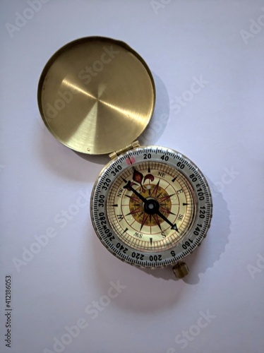 High Angle View Of Compass Over White Background