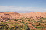 Fototapeta Sawanna - Desert landscape view of oasis old town village Ait Benhaddou, Morocco a historic fortified village, noted for its ancient clay earthen architecture.