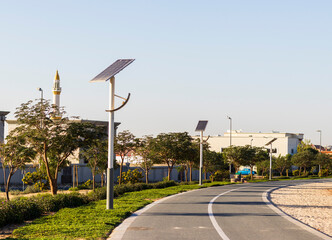 Wall Mural - Jogging and cycling tracks in Al Warqa park, Dubai, UAE early in the morning. Lamp post powered by solar panels can be seen in the picture. Outdoors