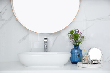 Modern bathroom interior with stylish mirror and vessel sink