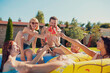 © Impact Photography - Friends making a toast with watermelon popsicles by the swimming pool