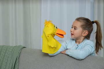 Poster - Cute little girl performing puppet show at home