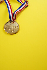 Poster - Close up of golden medal on the yellow background