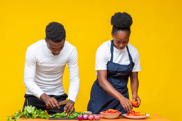 chef in a kitchen with a man preparing food together