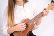 © Enrique Micaelo  - Young woman with guitar on white background with copy space