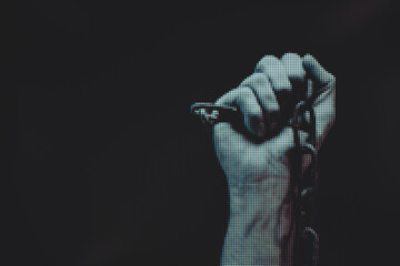 Poster - Human hand are chained in chains isolated on black background. Macro  photography view. Close-up of pixel.
