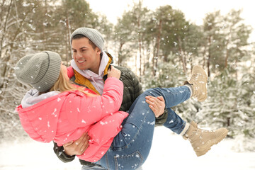 Sticker - Beautiful happy couple in snowy forest on winter day