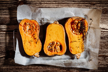 Wall Mural - Roasted pumpkins with thyme herbs on baking sheet