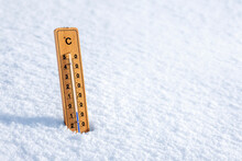 Thermometer In The Snow Background Concept For Winter And Freezing Temperature